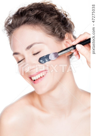 Black charcoal mask application on beautiful woman. Black charcoal mask application on beautiful woman. 47275038