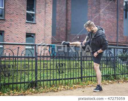 Outdoor stretching. Healthy exercising habits. 47275059