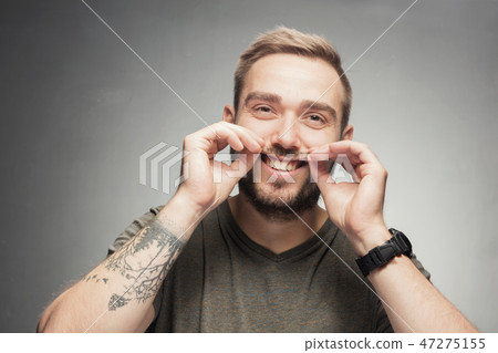 Young man making funny silly face 47275155