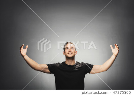 Attractive man smiling, spreading his arms. 47275500