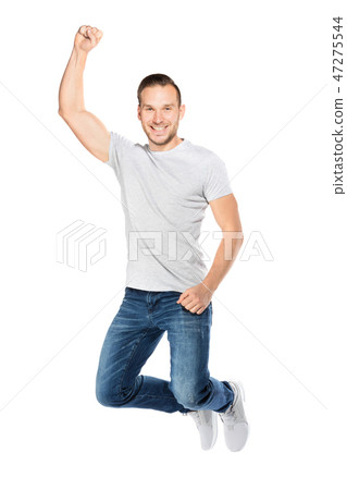 Young man jumping in a joyful expression. Young man jumping in a joyful expression. 47275544