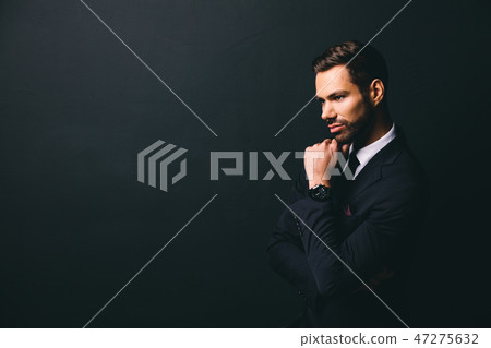 Young stylish businessman holding his chin 47275632