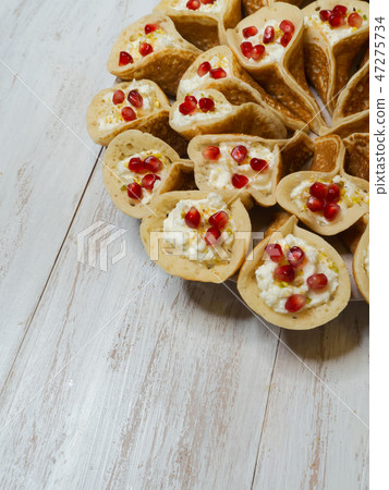 Qatayef, Arabian pancake stuffed with sweet cheese Qatayef, Arabian pancake stuffed with sweet cheese 47275734