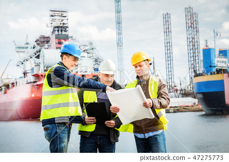 Shipbuilding engineers introducing new solution in a shipyard 47275773