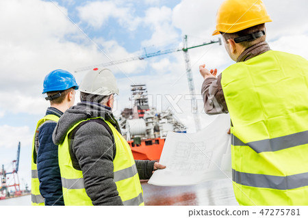 Shipbuilding engineers introducing new solution. Shipbuilding engineers introducing new solution. 47275781