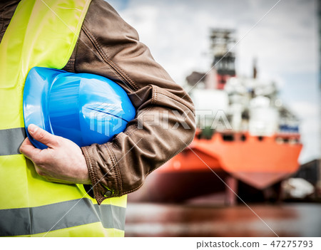 Shipbuilding engineer with safety helmet in shipyard Shipbuilding engineer with safety helmet in shipyard 47275793