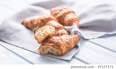 Fresh buttery croissants on kitchen napkin. 47277573