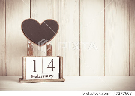 Valentines Day card with wooden block calendar on white wooden background witn copy space for text. Valentines Day card with wooden block calendar on white wooden background witn copy space for text. 47277608