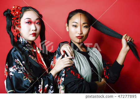 two pretty geisha girls friends: modern asian woman and traditional wearing kimono posing cheerful two pretty geisha girls friends: modern asian woman and traditional wearing kimono posing cheerful 47277895