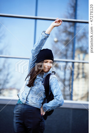 young pretty girl near business building walking 47278120