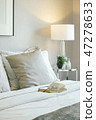 Glasses and book on bed in modern interior bedroom 47278633