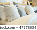 Closeup roll of pillows setting on comfortable bed 47278634