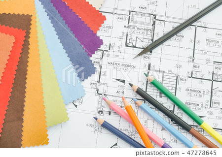 Architectural drawing with material on work table 47278645