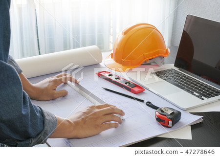 architect working on table with blueprint and tool 47278646