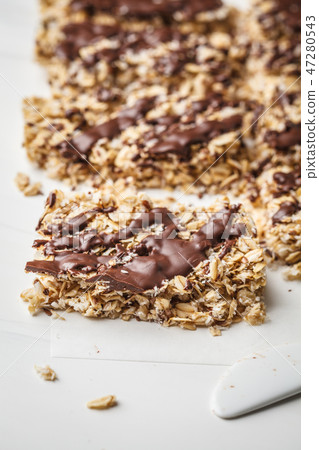 Homemade chocolate oat bars on a white  47280543