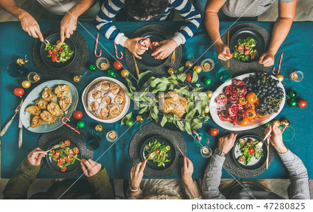 People eating different meals at Christmas party 47280825