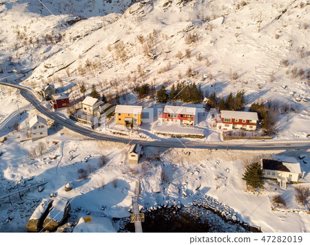 Colorful fishing house on coastline in snowfall Colorful fishing house on coastline in snowfall 47282019