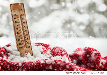 thermometer with sub zero temperature sticks out in a snowdrift thermometer with sub zero temperature sticks out in a snowdrift 47282484