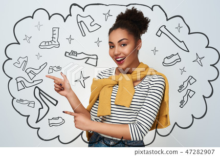Young woman studio isolated in white pointing aside on wall look 47282907