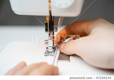 Closeup the sewing machine and item of clothing 47284254