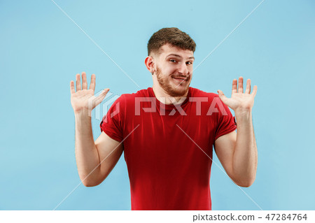 Beautiful male half-length portrait isolated on blue studio backgroud. The young emotional surprised Beautiful male half-length portrait isolated on blue studio backgroud. The young emotional surprised 47284764