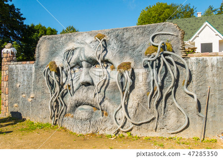 man-made wall with a picture of a human face on it man-made wall with a picture of a human face on it 47285350