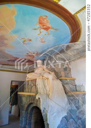 a statue of a naked woman on a stone fireplace und a statue of a naked woman on a stone fireplace und 47285352