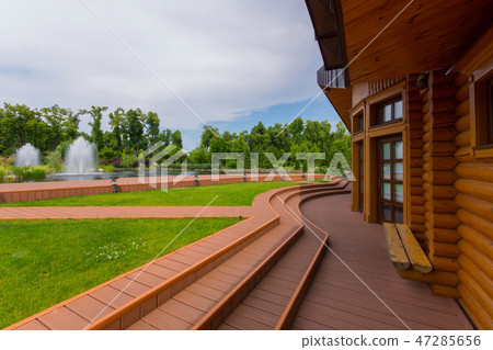 A log house with wooden trails running through a g A log house with wooden trails running through a g 47285656