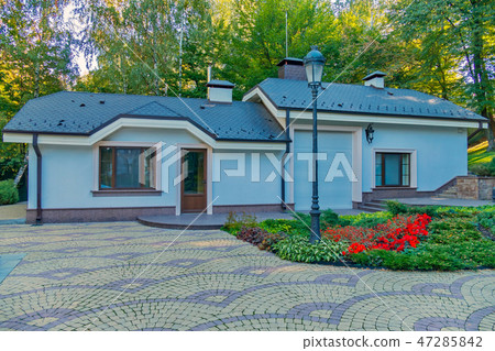 a clean, spacious yard with a flower bed in front a clean, spacious yard with a flower bed in front 47285842