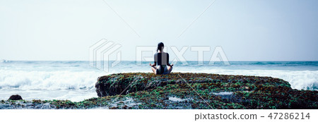 Woman meditation at the seaside croal cliff edge  47286214