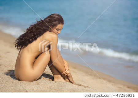 Nude beautiful woman on the nudist beach. Lady with nude perfect body. Nude beautiful woman on the nudist beach. Lady with nude perfect body. 47286921