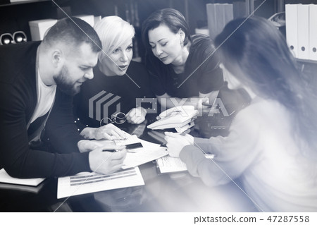 Smiling employees talking in workplace 47287558