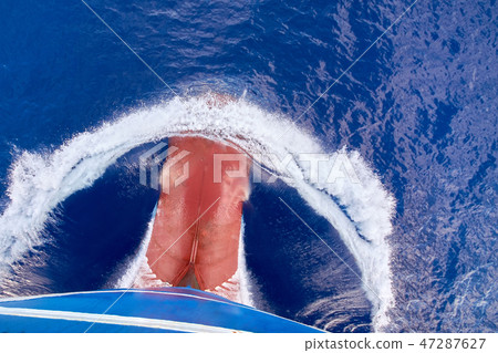 View from top on bulbous bow of ship underway. 47287627