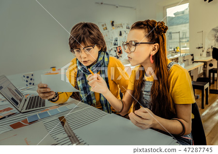 Two schoolchildren wearing glasses attending design school Two schoolchildren wearing glasses attending design school 47287745