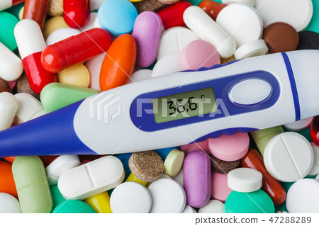 Pills and electronic thermometer - medical backgr Pills and electronic thermometer - medical backgr 47288289