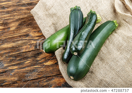 fresh zucchini on a natural brown wooden fresh zucchini on a natural brown wooden 47288737