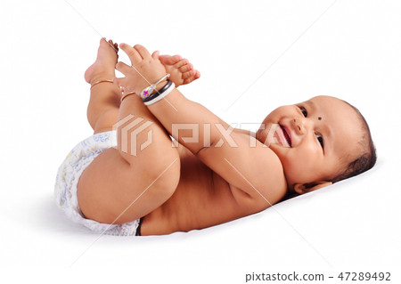 Cute baby sleeping on bed holding his feet, Pune Cute baby sleeping on bed holding his feet, Pune 47289492