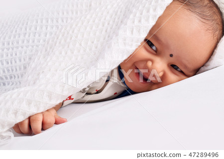 Cute baby sleeping on bed and laughing, Pune Cute baby sleeping on bed and laughing, Pune 47289496
