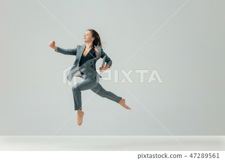 Happy business woman dancing and smiling isolated over white. 47289561
