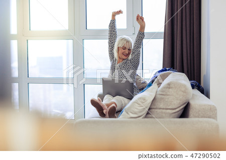 Joyful nice good looking woman stretching herself 47290502