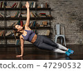 Fitness woman doing side plank during yoga workout at home 47290532