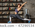 Young fitness woman doing front lunge during yoga exercise 47290534