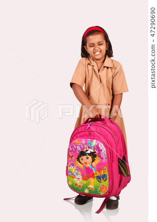 Little girl in school uniform picking a school bag 47290690