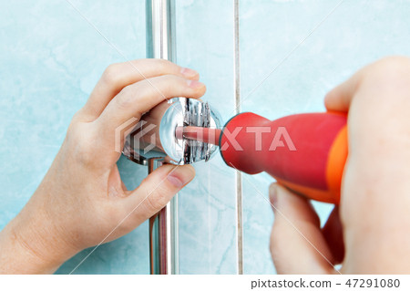 Worker hand adjusts angle adjustable bracket Worker hand adjusts angle adjustable bracket 47291080