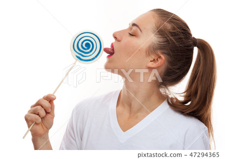 Close-up of woman licking lollipop candy Close-up of woman licking lollipop candy 47294365