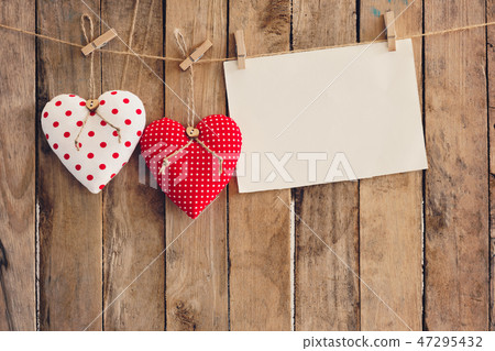 Heart and empty paper hanging on wood background Heart and empty paper hanging on wood background 47295432