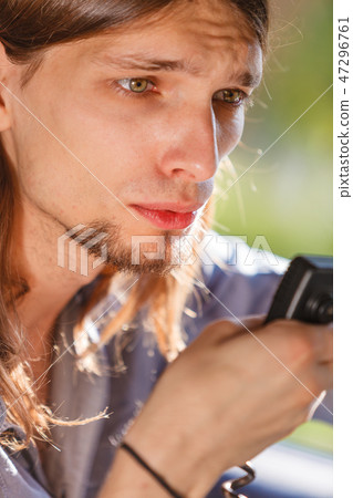 Young man driving car using cb radio Young man driving car using cb radio 47296761