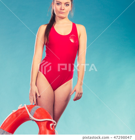 Lifeguard woman on duty with ring buoy lifebuoy. 47298047