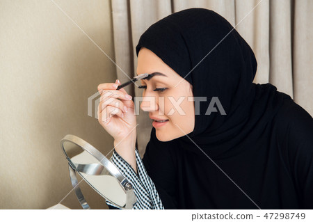 close-up portrait of charming Muslim woman wearing makeup. do face 47298749