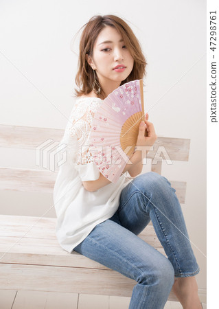 A woman with a fan A woman with a fan 47298761